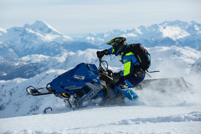 a person riding a snowmobile for how to measure for a snowmobile cover